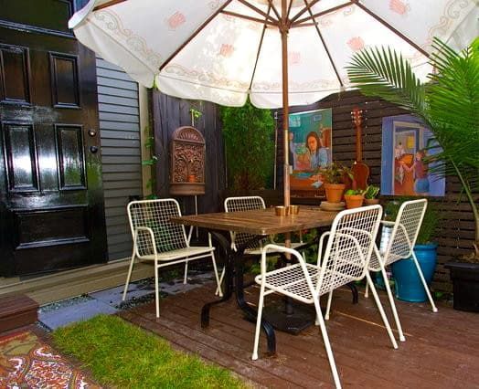A patio with a table and chairs under an umbrella