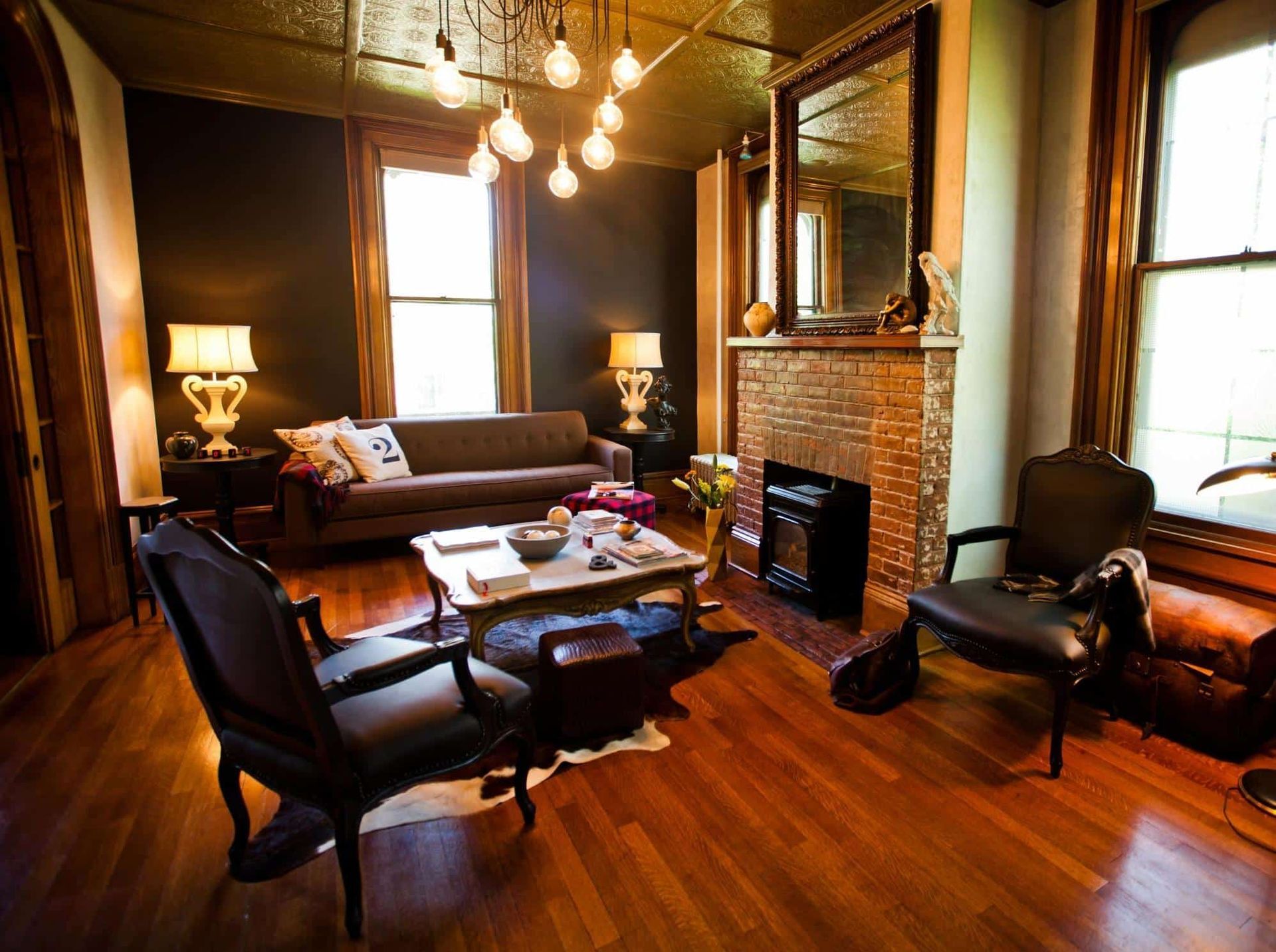 A living room with a couch , chairs , coffee table and fireplace.