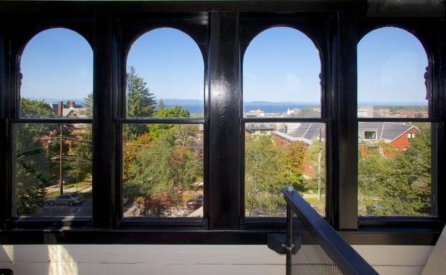 A view of a city from a window with arched windows