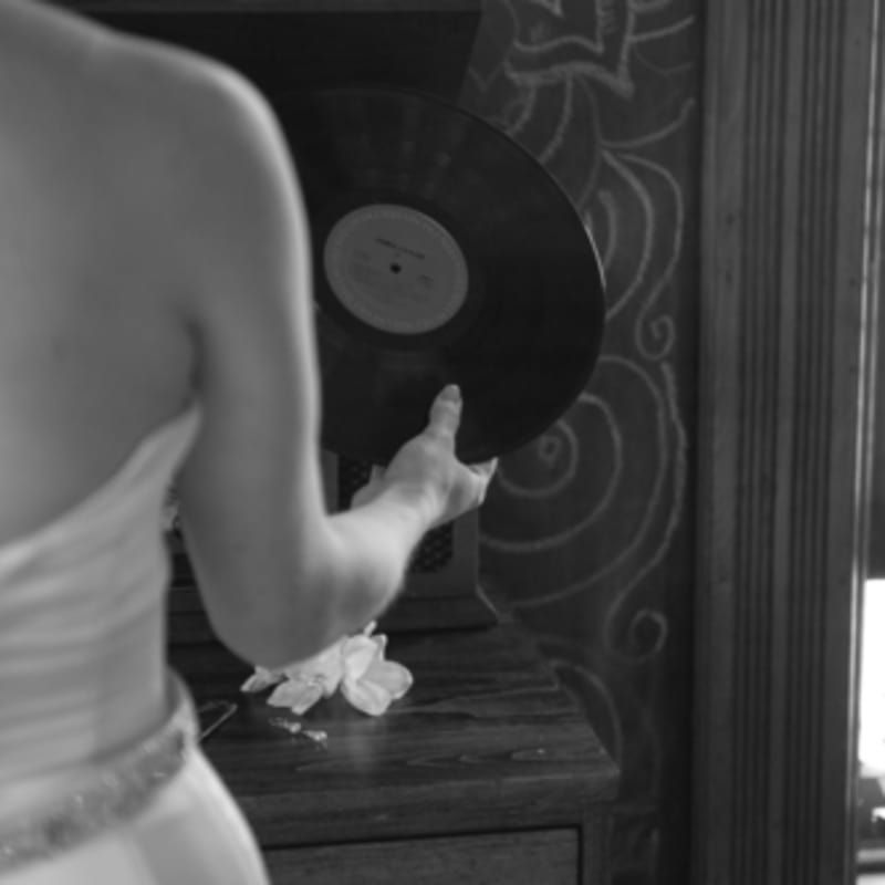 A black and white photo of a woman holding a record