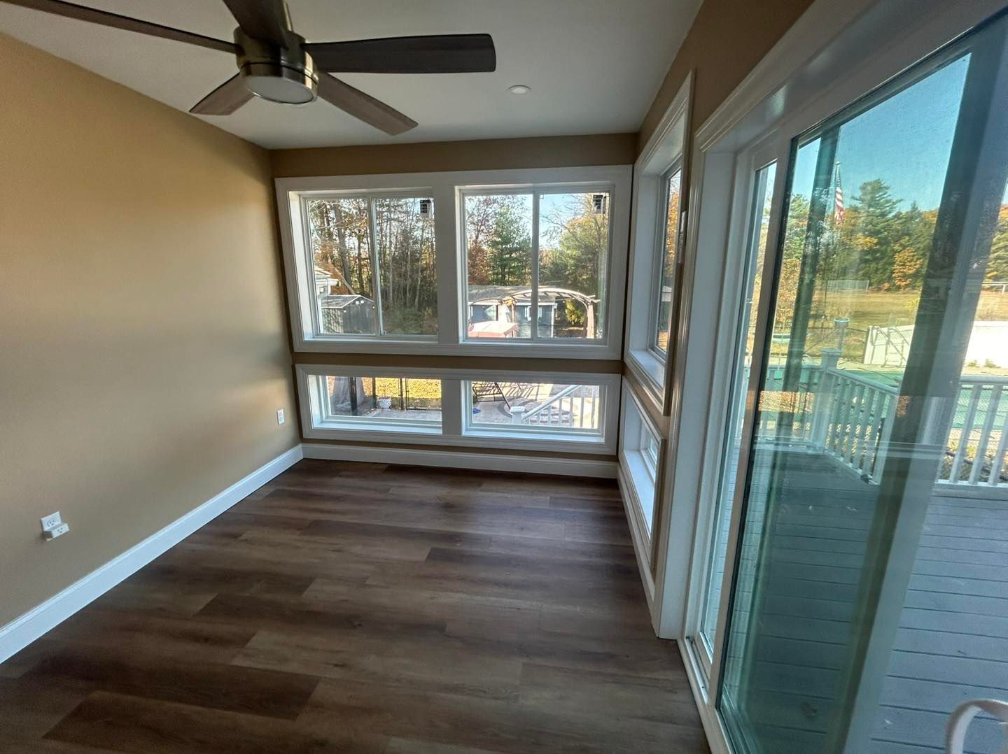 Interior with hardwood floors, three room openings, and dining table. Beige walls with natural light.