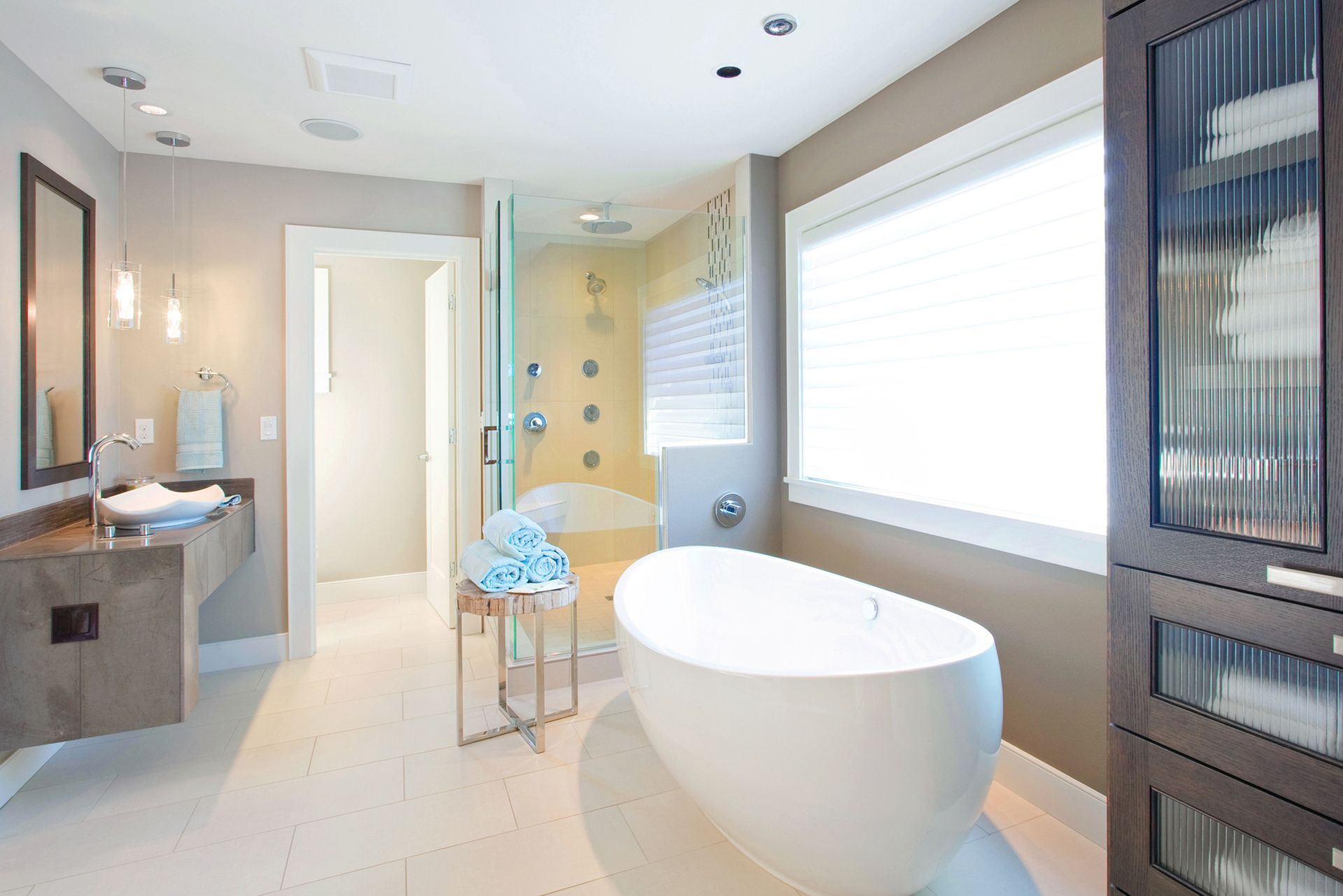 Modern bathroom with a freestanding tub, glass shower, and vanity.