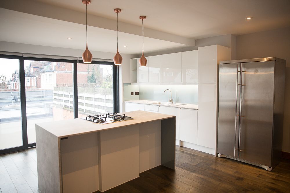 Modern home with wood paneling, white garage, and minimalist landscaping.