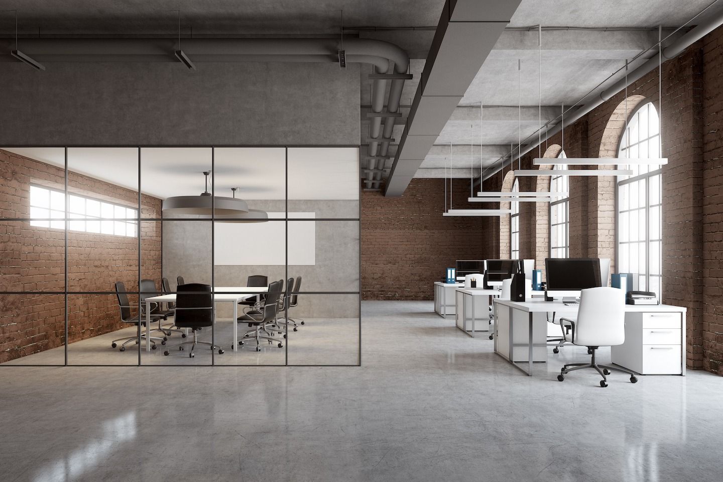 Industrial-style office with brick walls, glass meeting room, and white desks.