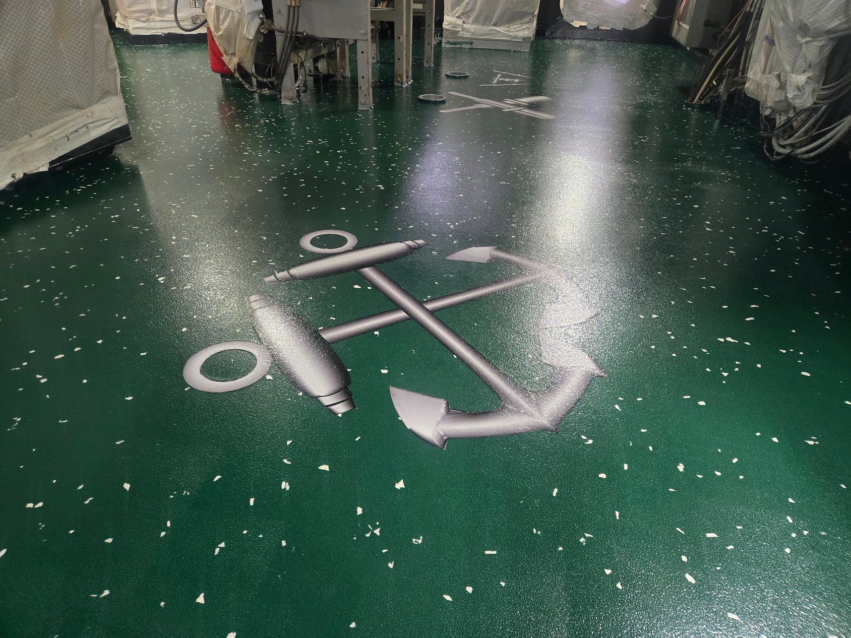 Green floor with white flecks and a painted anchor symbol.