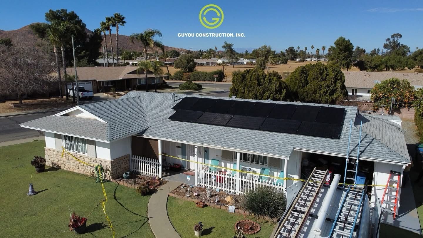 A house with solar panels on the roof. A lift platform is next to the building.