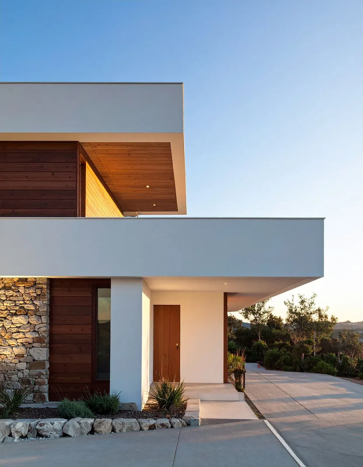 New two-story house under construction with stone facade and unfinished garage.