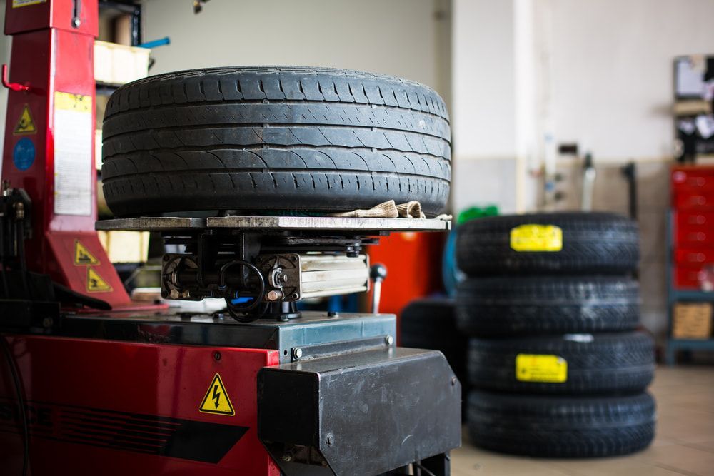 A Tire is Sitting on Top of a Machine in a Garage — Switch Gear Automotive in Riverstone, NSW
