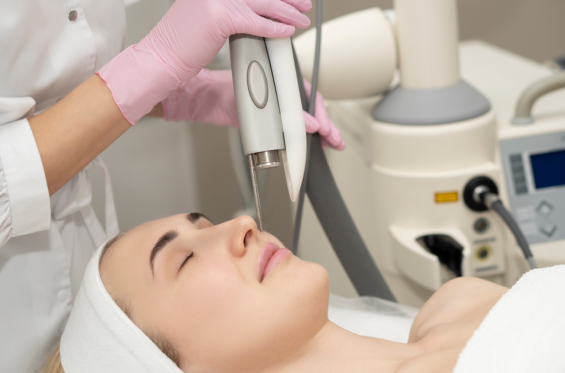 A woman is getting a facial treatment at a beauty salon.