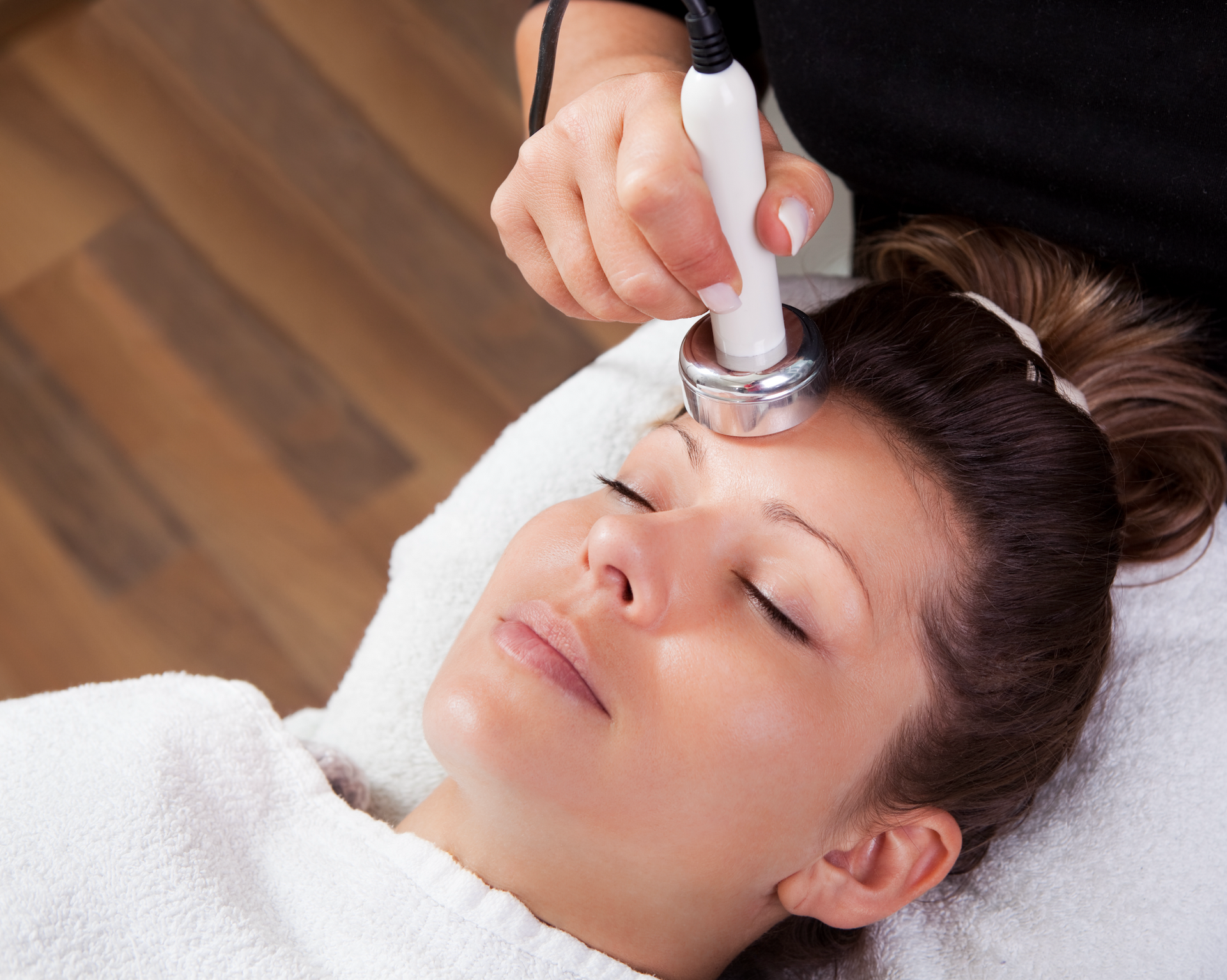 A woman is getting a facial treatment at a beauty salon.