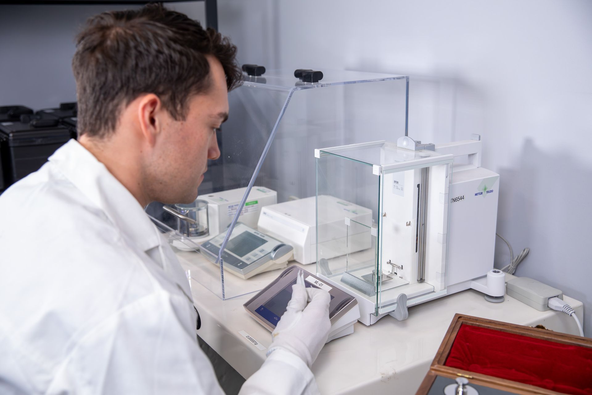 Black ASUS laptop displays a green and white software interface. The screen shows a large number 