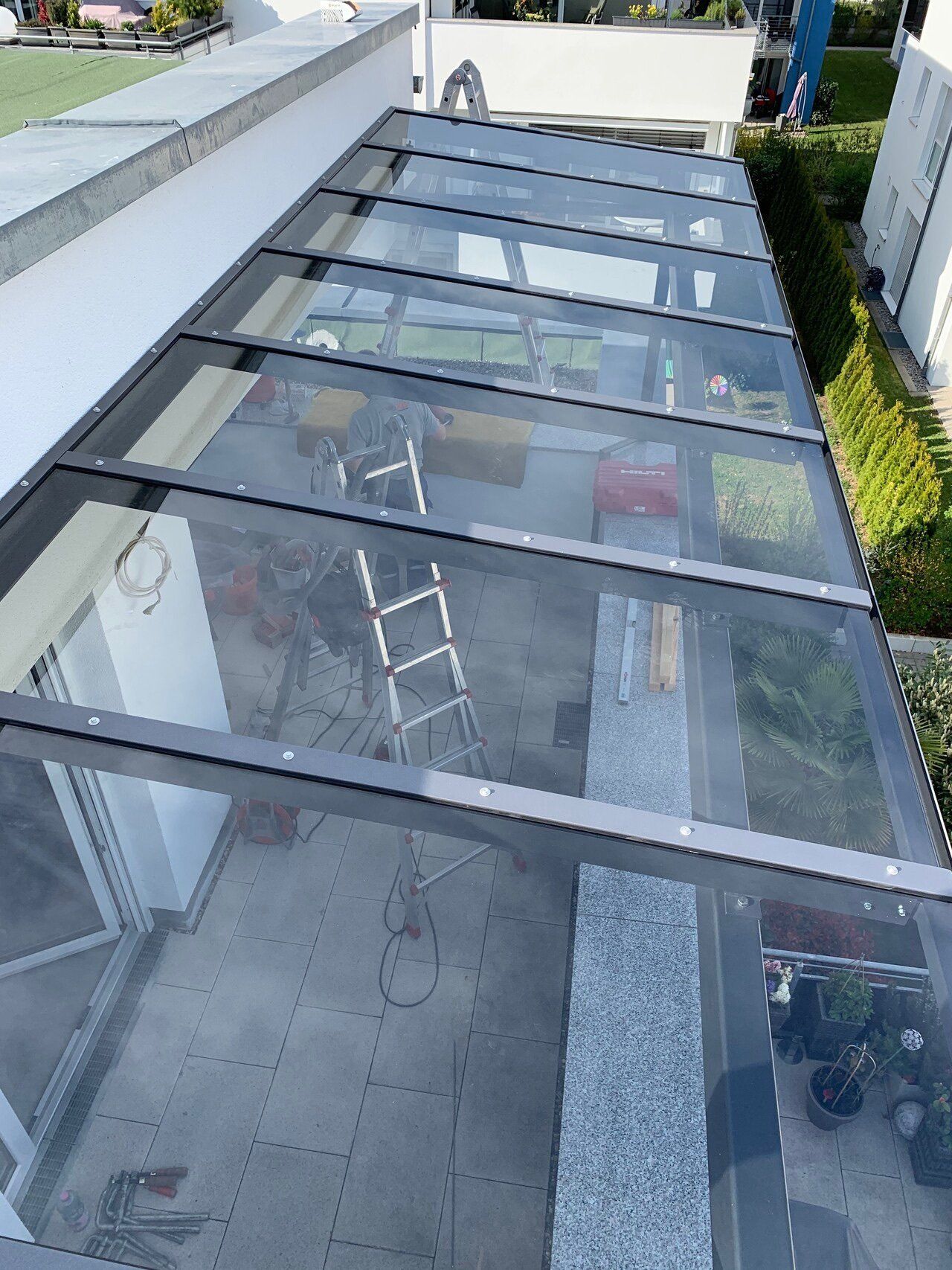 Eine Leiter steht unter einem klaren Glasdach