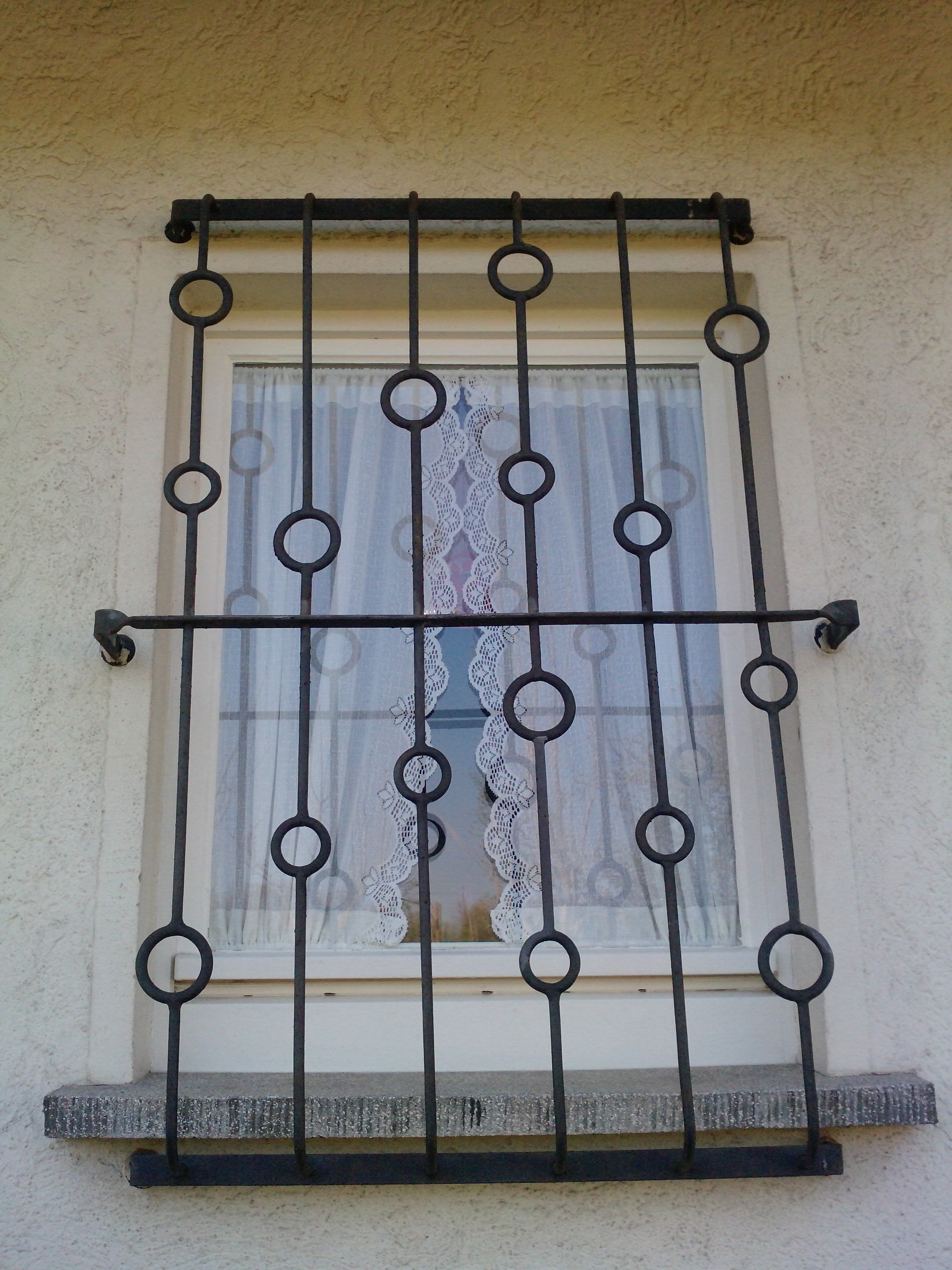 Ein Fenster mit einem schmiedeeisernen Gitter