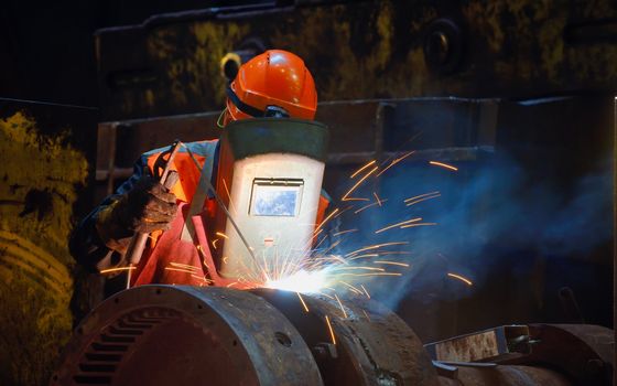 welder wearing a safety helmet while working