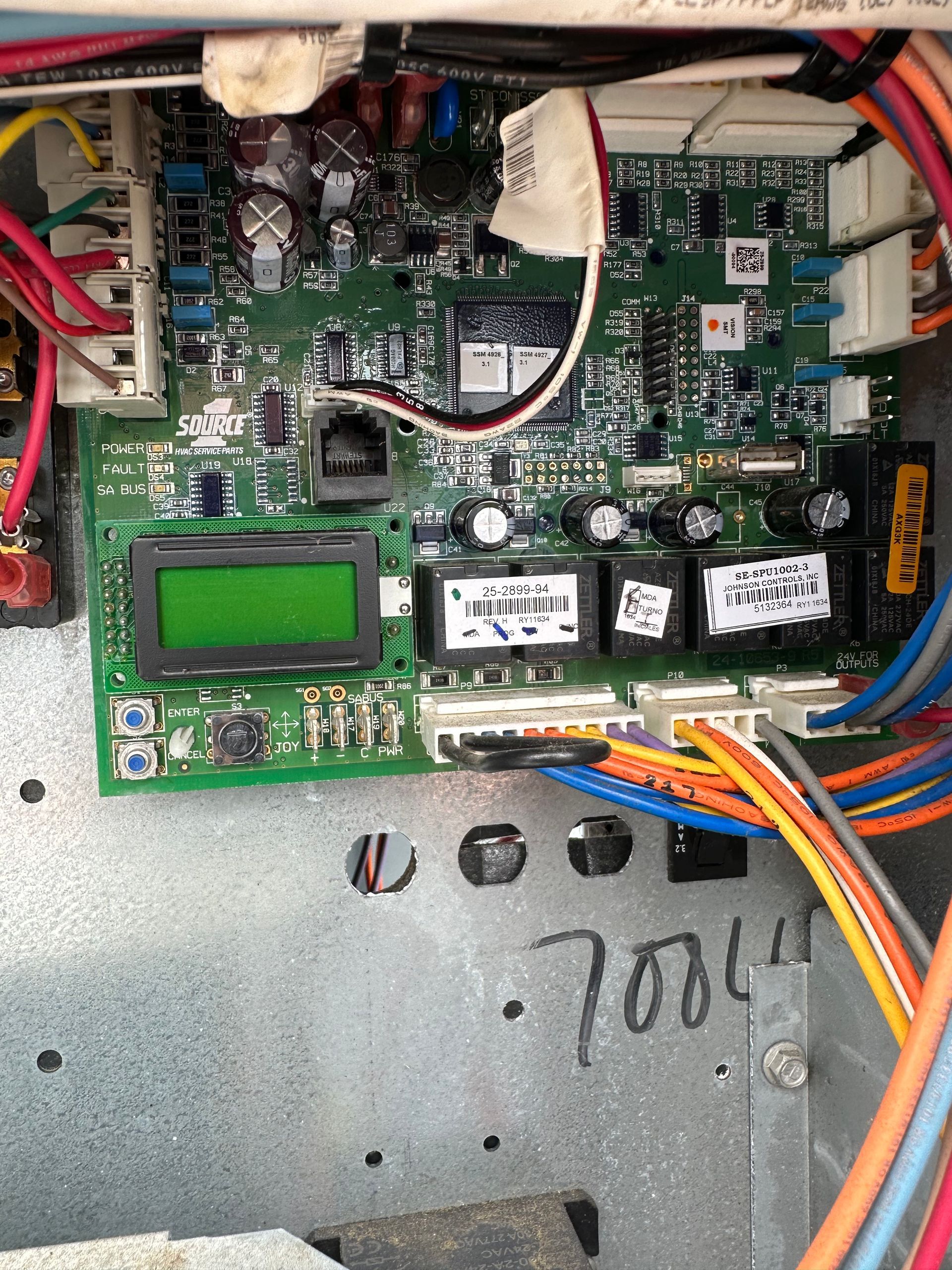 Circuit board inside a metal box with an LCD screen and wires. Green, black, blue, and orange wires are visible.