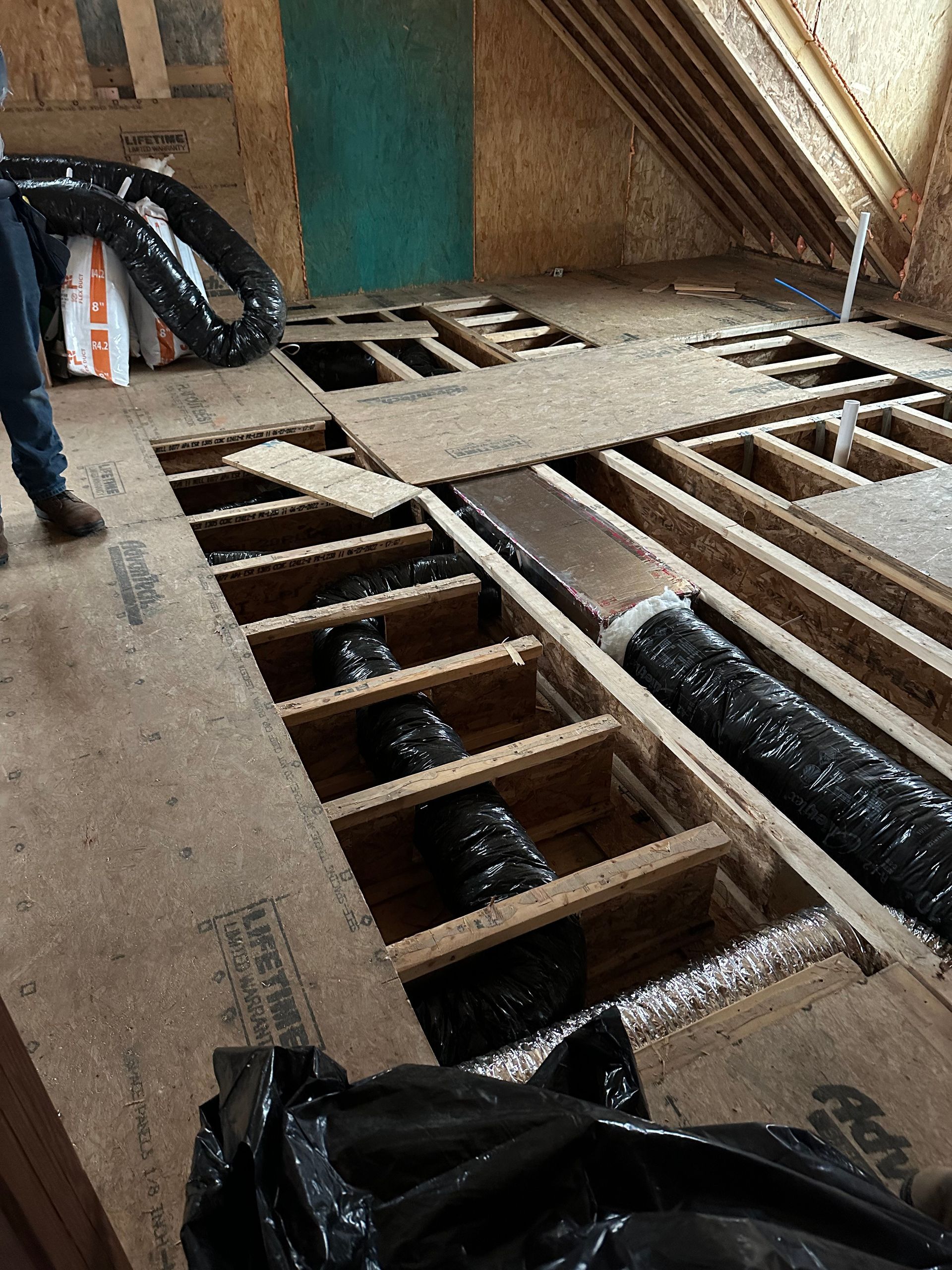 Interior construction showing exposed floor joists with HVAC ductwork.
