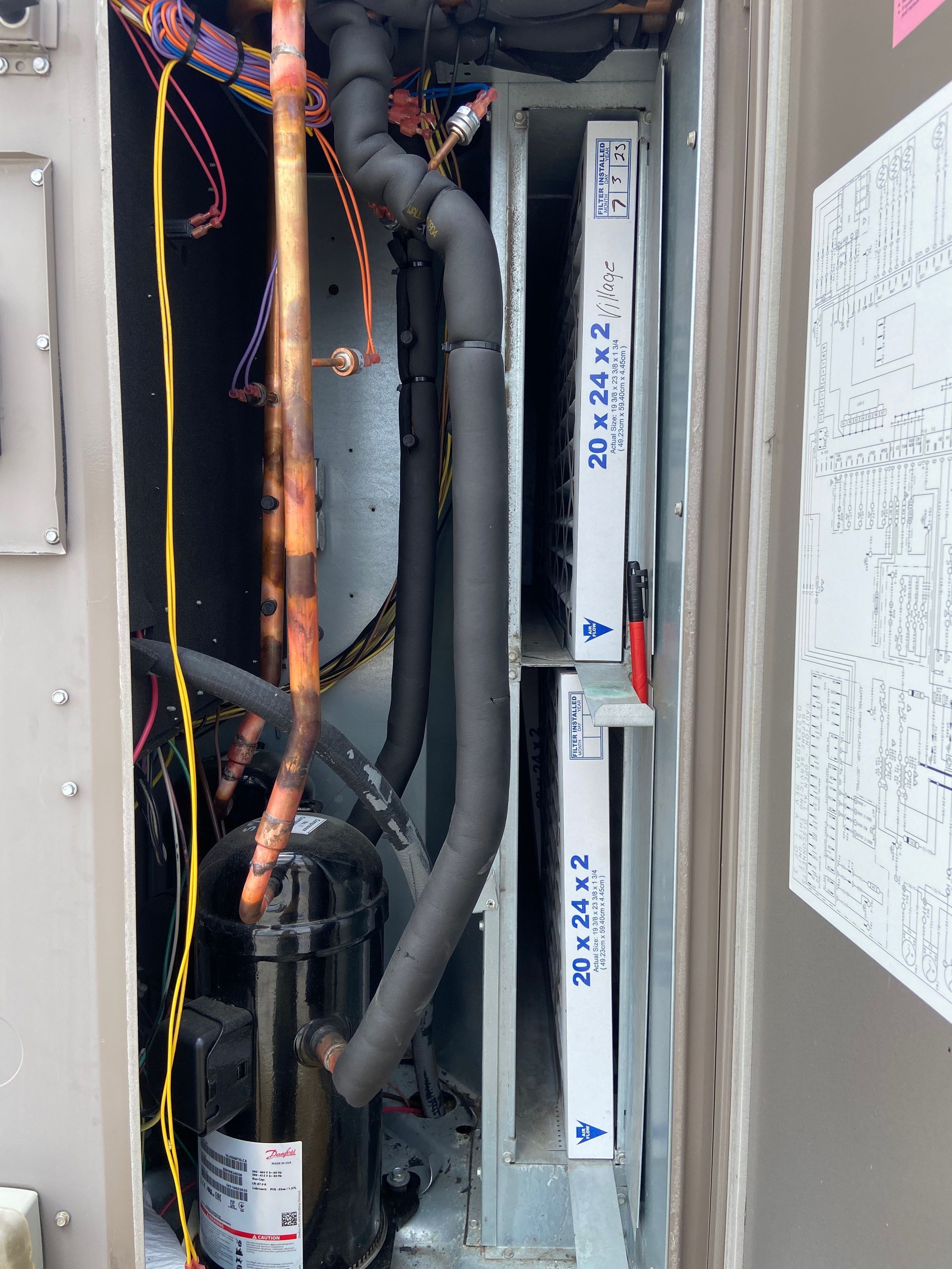 Open air conditioning unit with two 20x24x2 filters, compressor, and copper tubing.