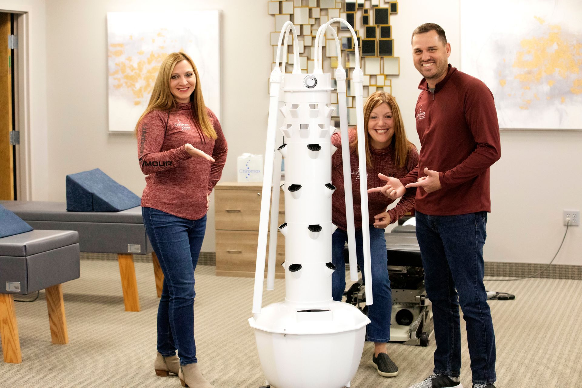 Dr. Shelby, Dr. Cooper, & Colleen standing next to their tower garden