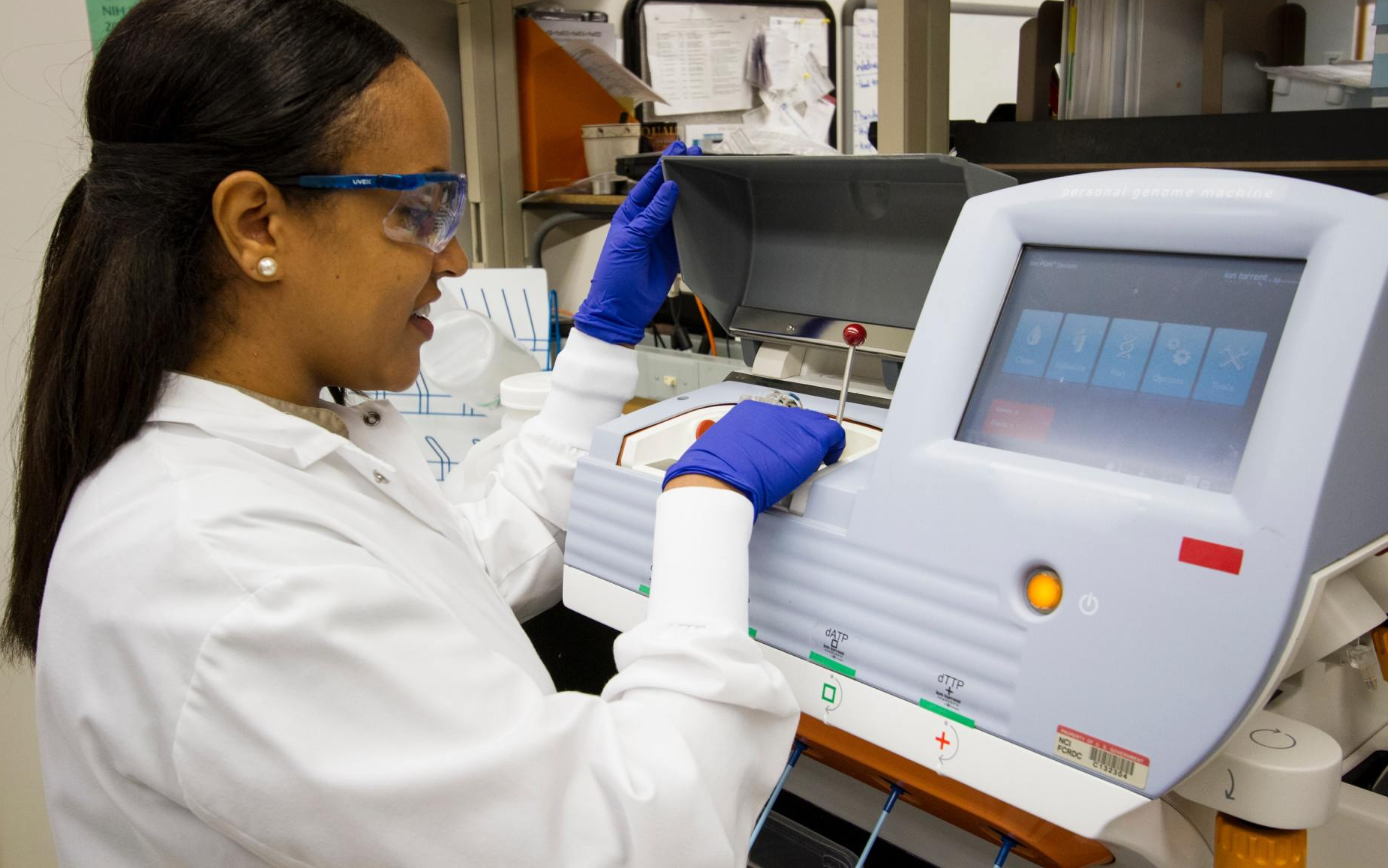 young female medical student using research lab equipment