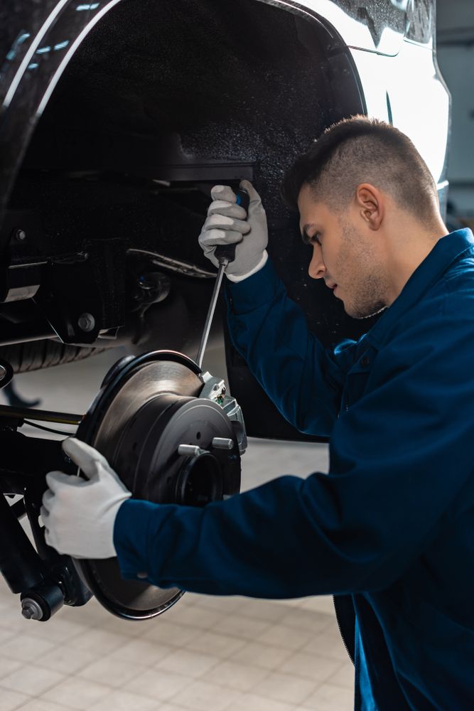 Attentive Mechanic Adjusting Brake Caliper — Gold Coast Service Centre In Southport, QLD