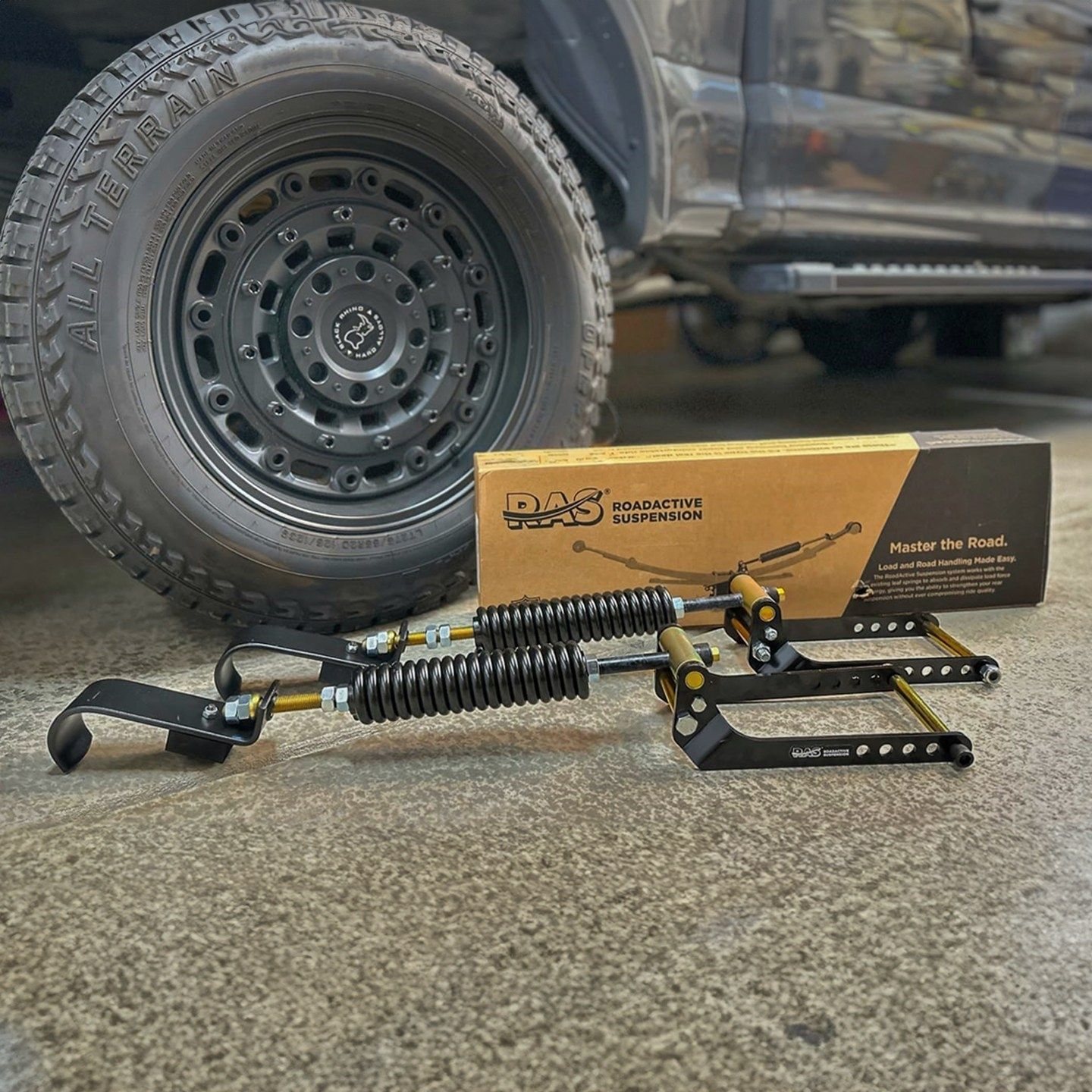 A Close Up of a Car Suspension With a Tire in the Background — Gold Coast Service Centre In Southport, QLD