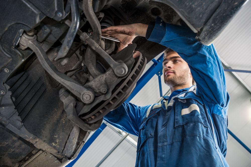 Low Angle View of Male Mechanic Repairing Suspension System — Gold Coast Service Centre In Southport, QLD