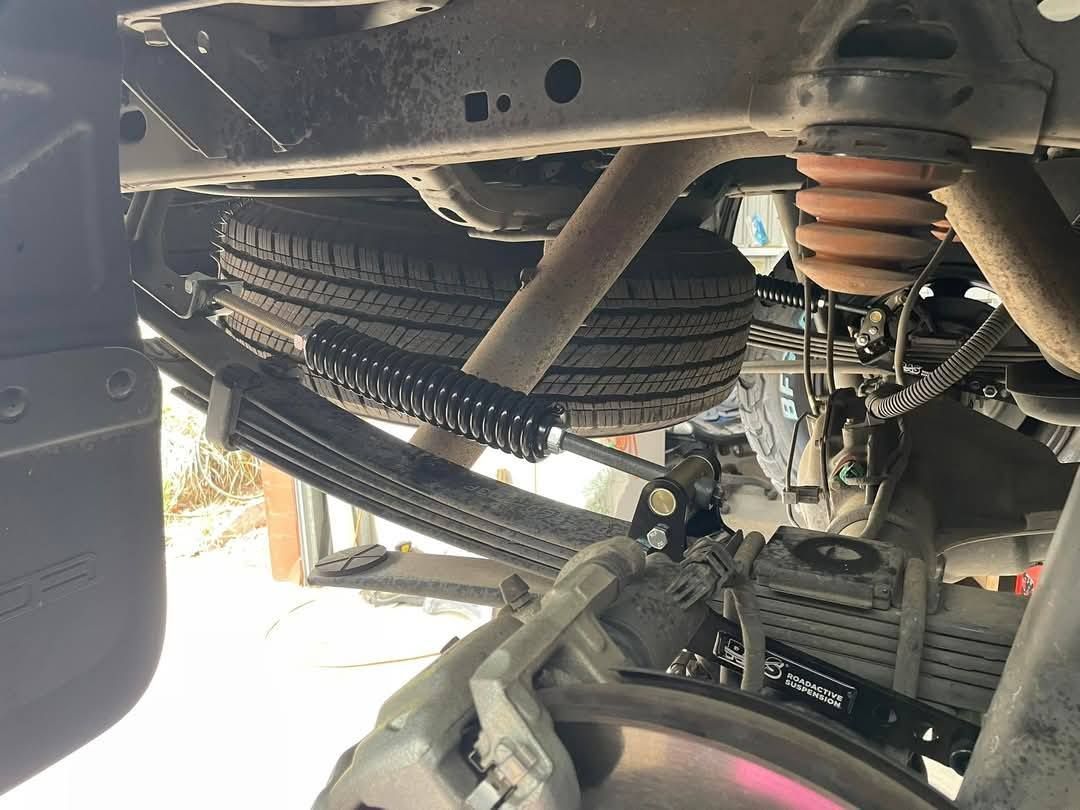 A Person is Cleaning a Motorcycle With a Brush — Gold Coast Service Centre In Southport, QLD