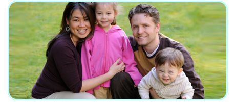 Happy family sitting on the grass together