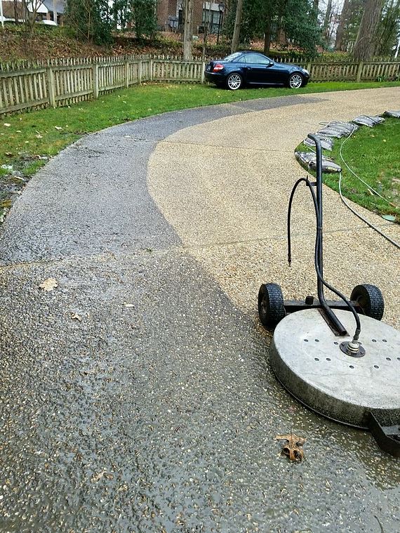 exposed aggregate concrete driveway half cleaned and half dirty