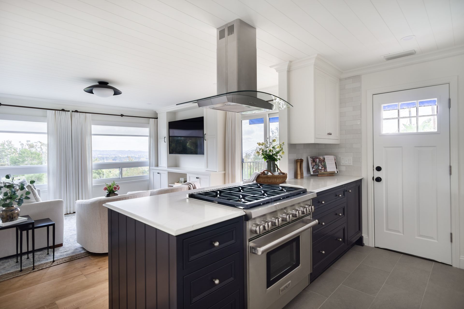 A kitchen with stainless steel appliances and a large island.