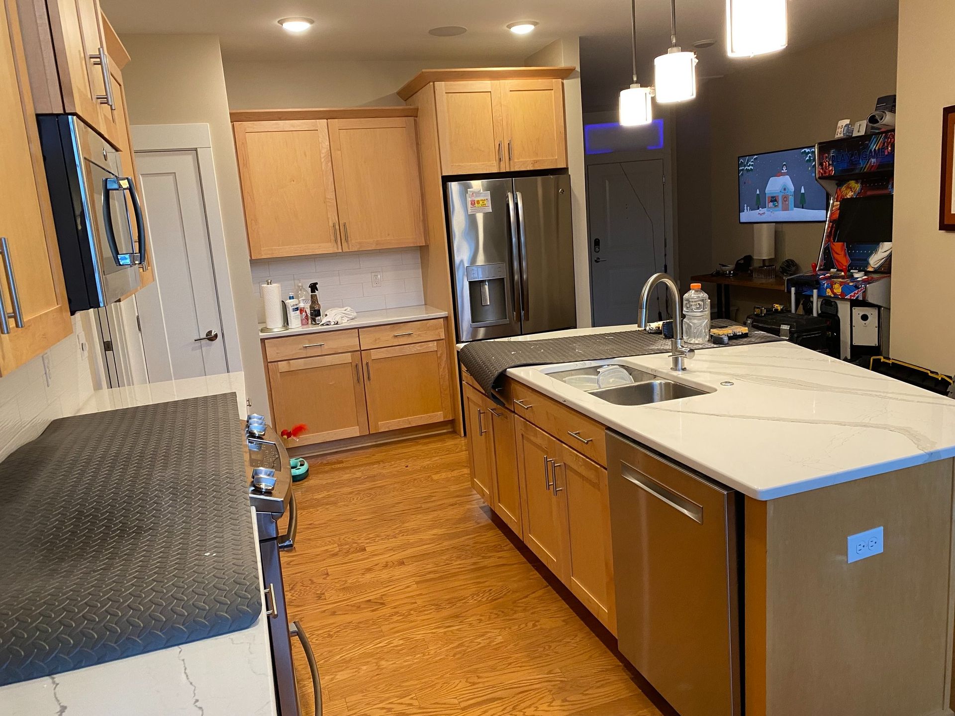 A kitchen with stainless steel appliances and wooden cabinets
