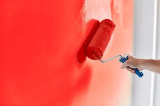 House Painting — Male Hand Painting The Wall With Paint Roller In York, PA