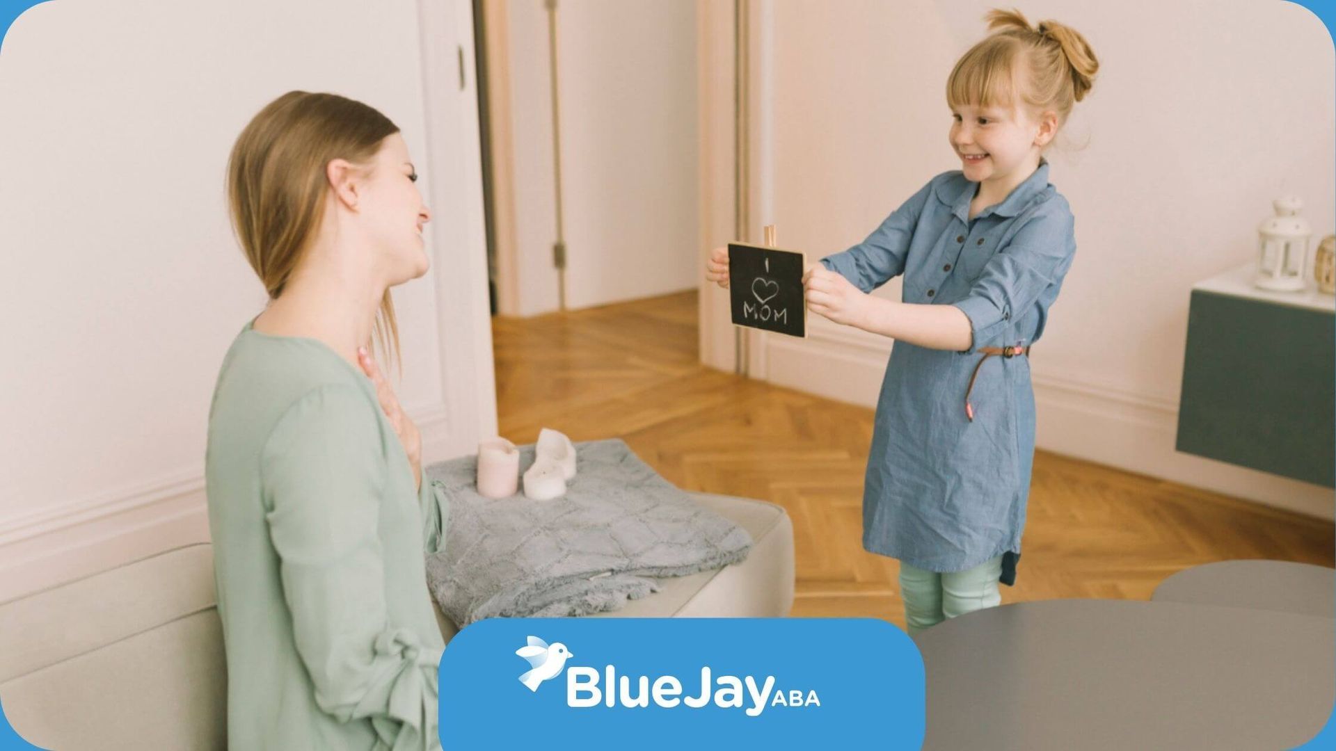 A girl with autism giving her mom a card that says “I love mom.”