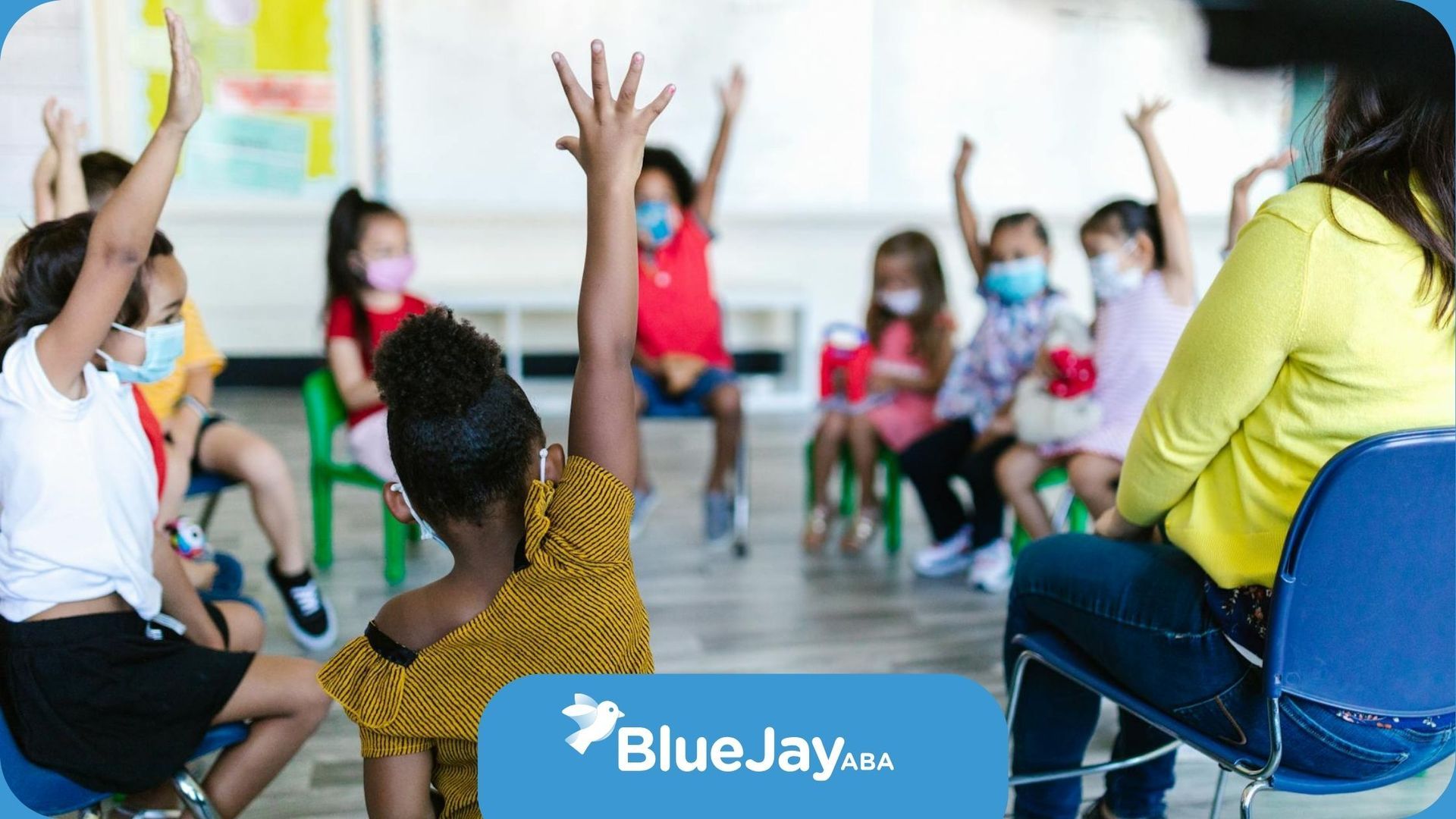 Autistic children raising their hands during center-based ABA therapy with an RBT in North Carolina.