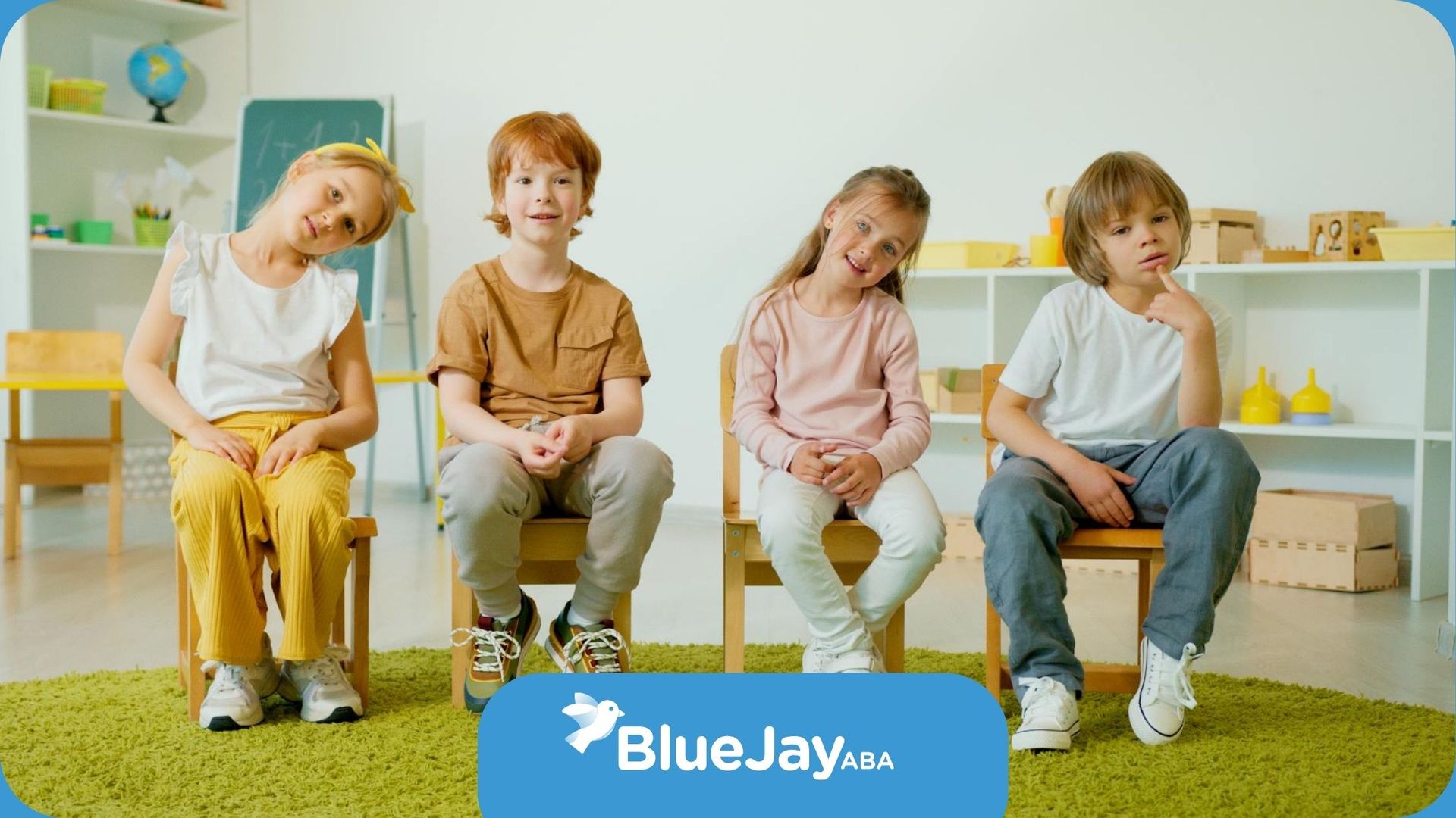 Four young autistic children are sitting in a row in a classroom with playful expressions in CO.
