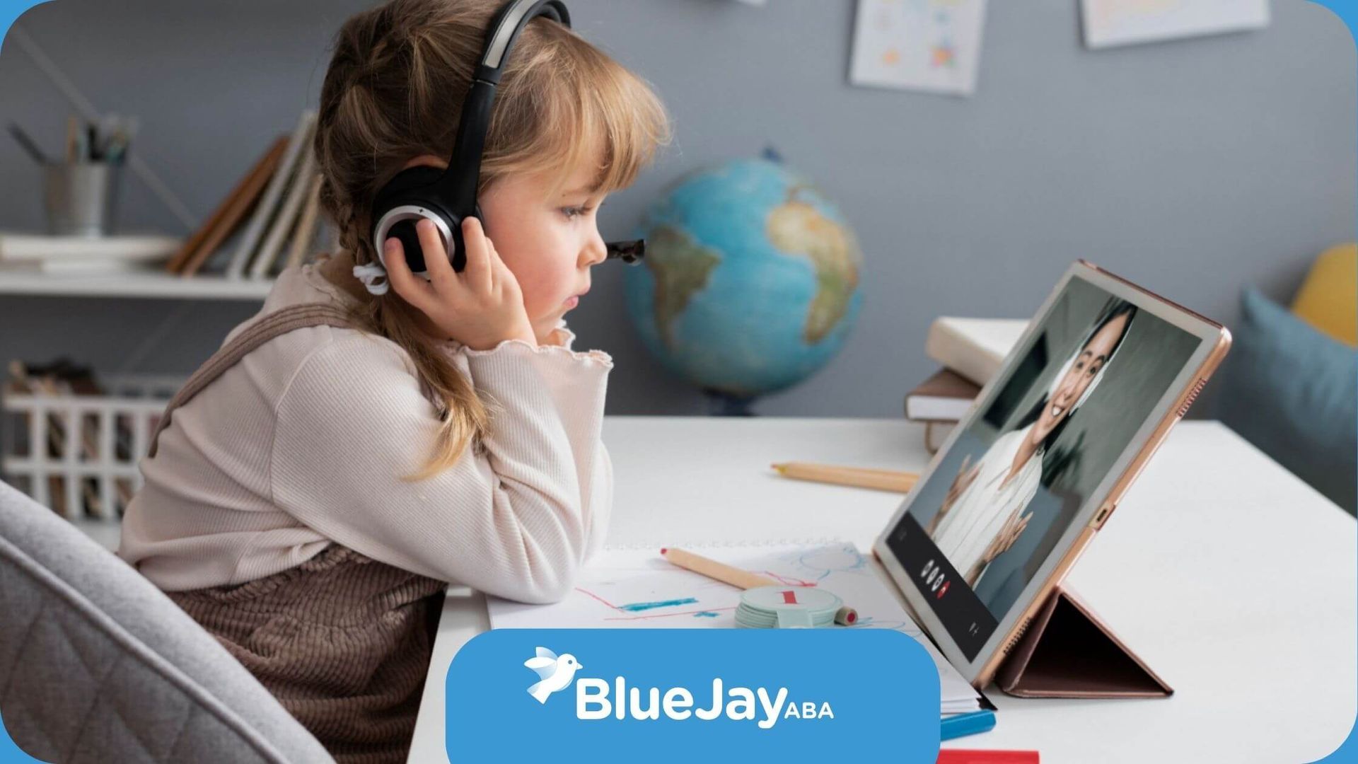Little girl attending an online ABA therapy session with headphones.