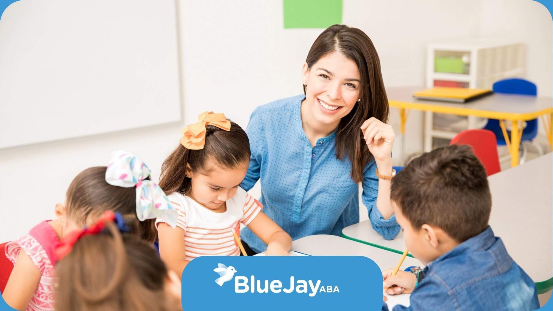 A teacher is teaching a group of children in a classroom.