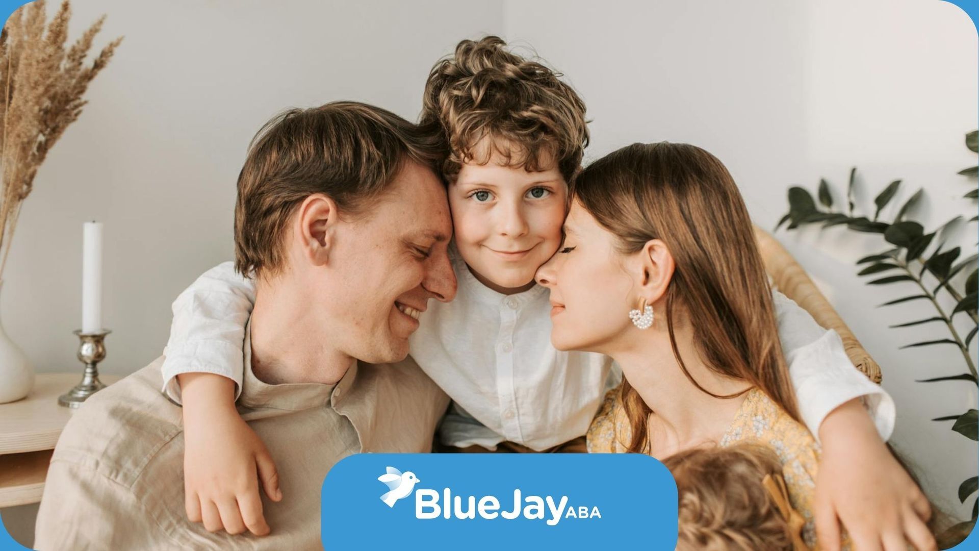 Family of three cuddling warmly with a happy and smiling autistic child at the center in Maryland.