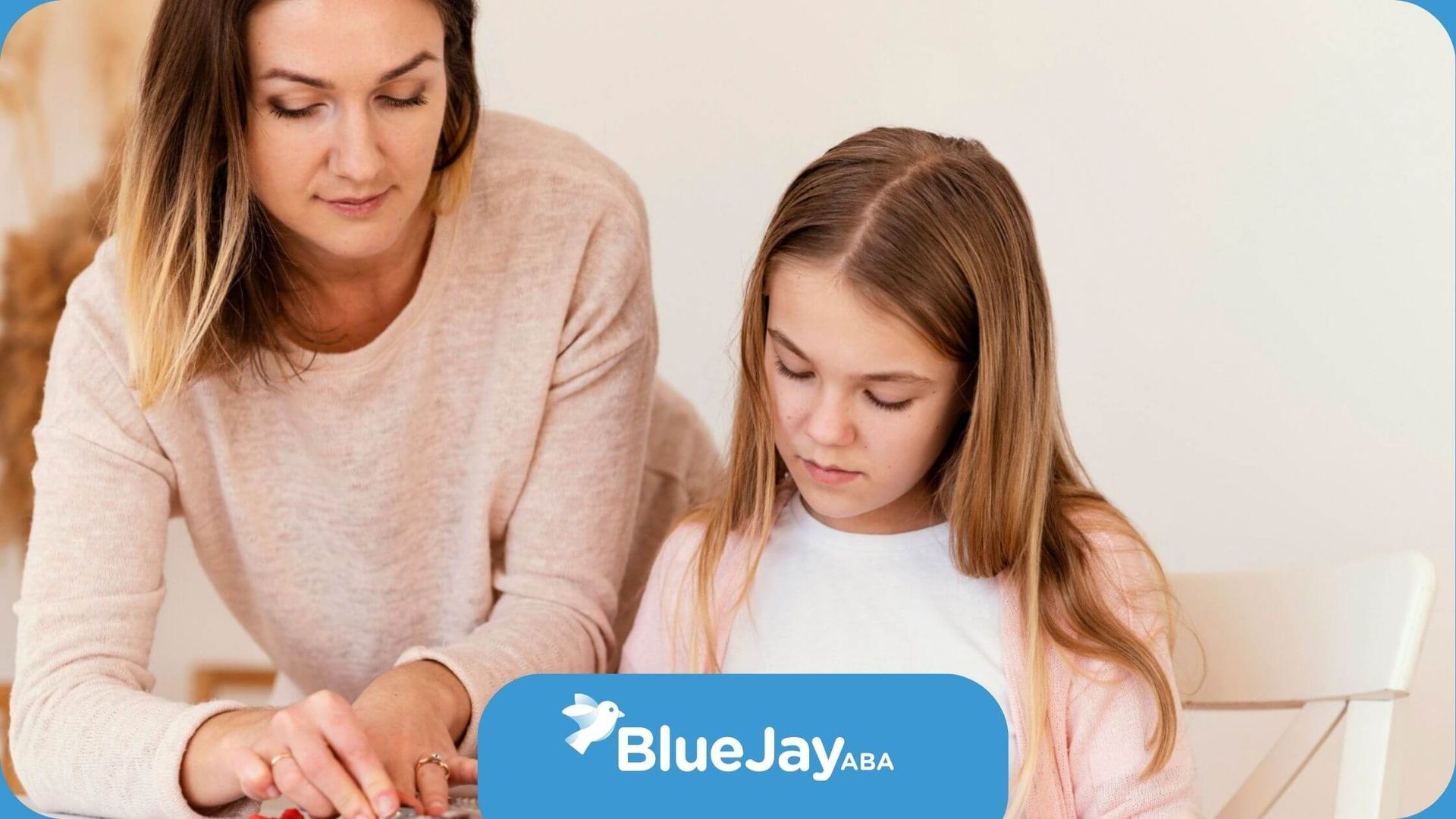An ABA therapist and a girl are sitting at a table playing with toys in ABA therapy.