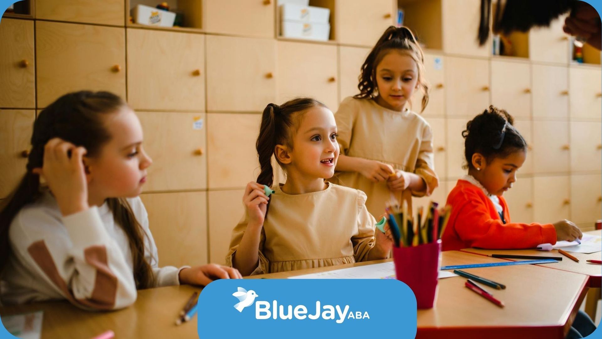 Autistic children engaged in classroom activities, drawing and interacting at a table in Maryland.