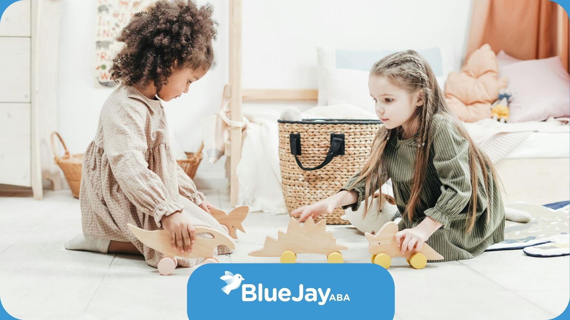 Two young autistic girls sitting on floor playing with wooden animal toys during ABA therapy in NC.