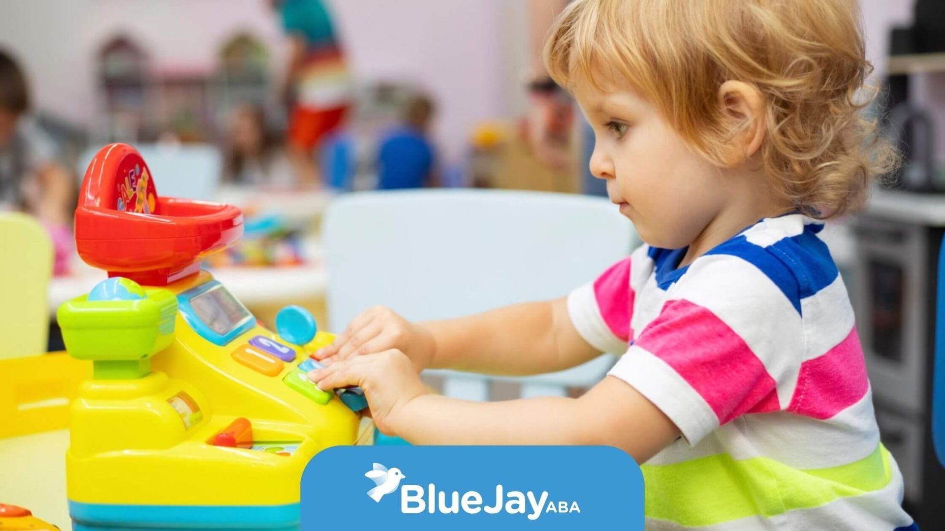 A child with autism playing with a colorful toy cash register during ABA therapy.