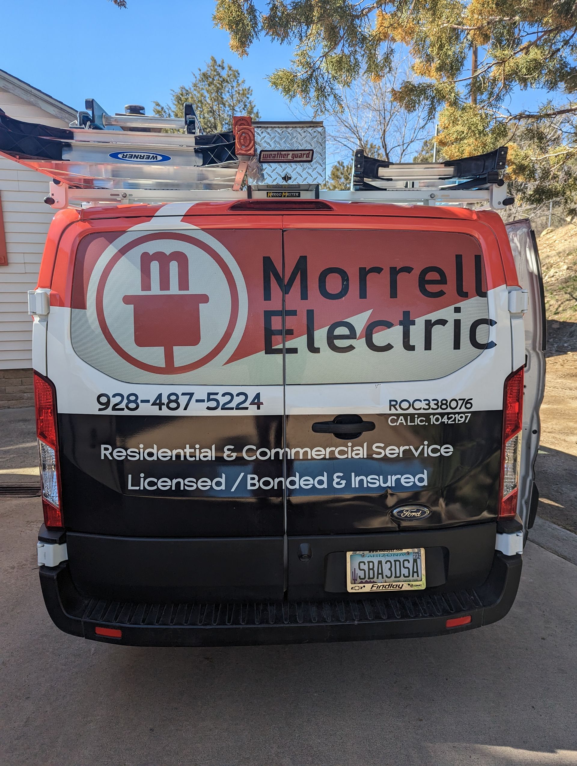 Back of a white van labeled 