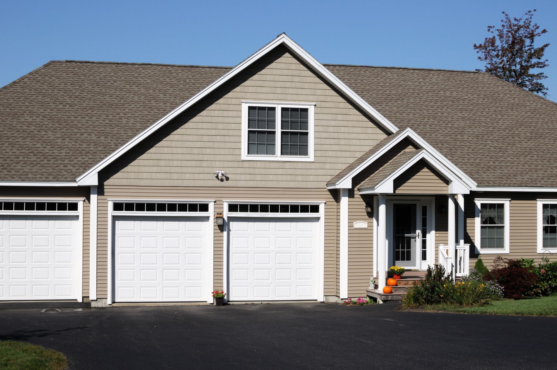 the front of a house with three garage doors