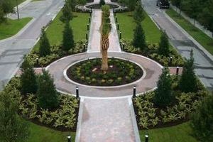 An aerial view of a circular walkway with a tree in the middle