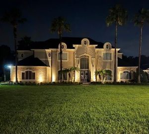A house with a large lawn in front of it