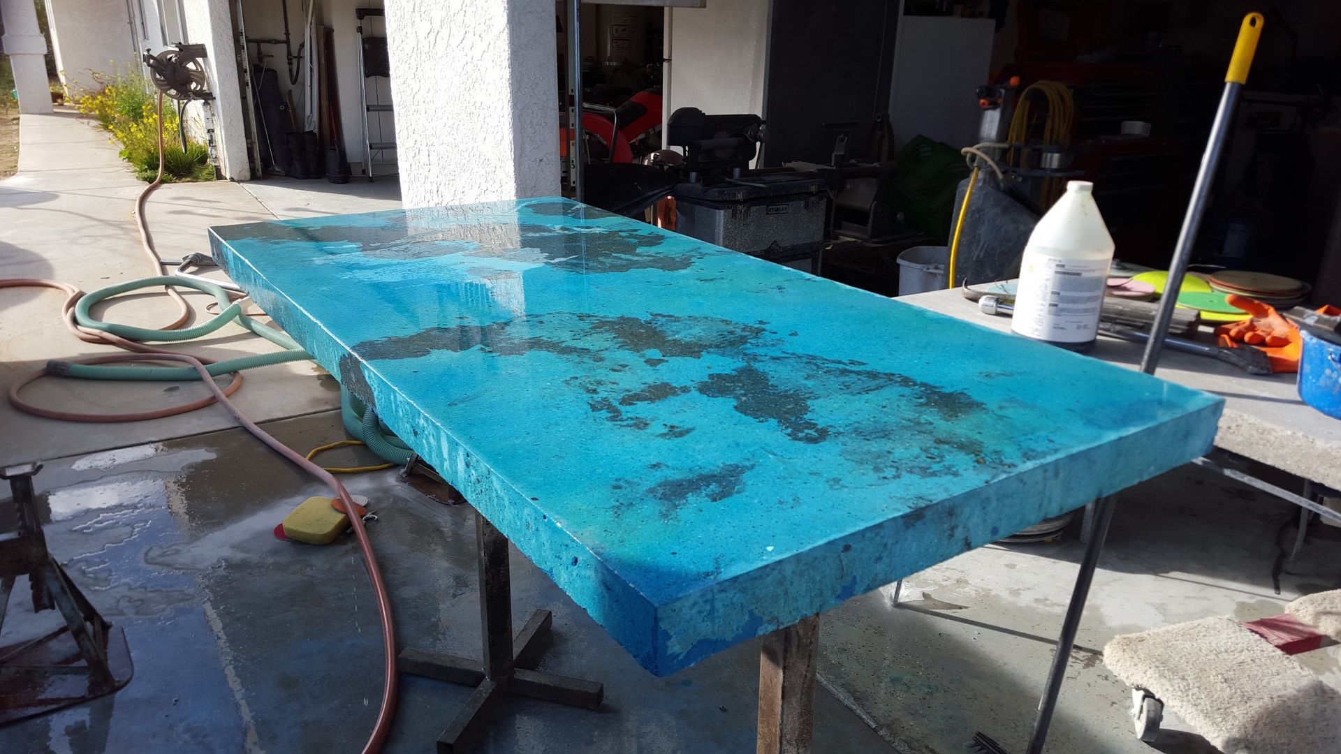 A blue table is sitting on a table in a garage.