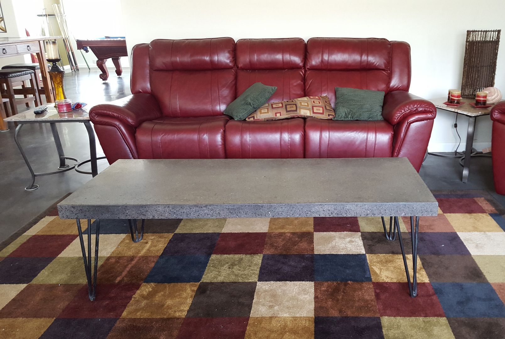 A living room with a red couch and a coffee table