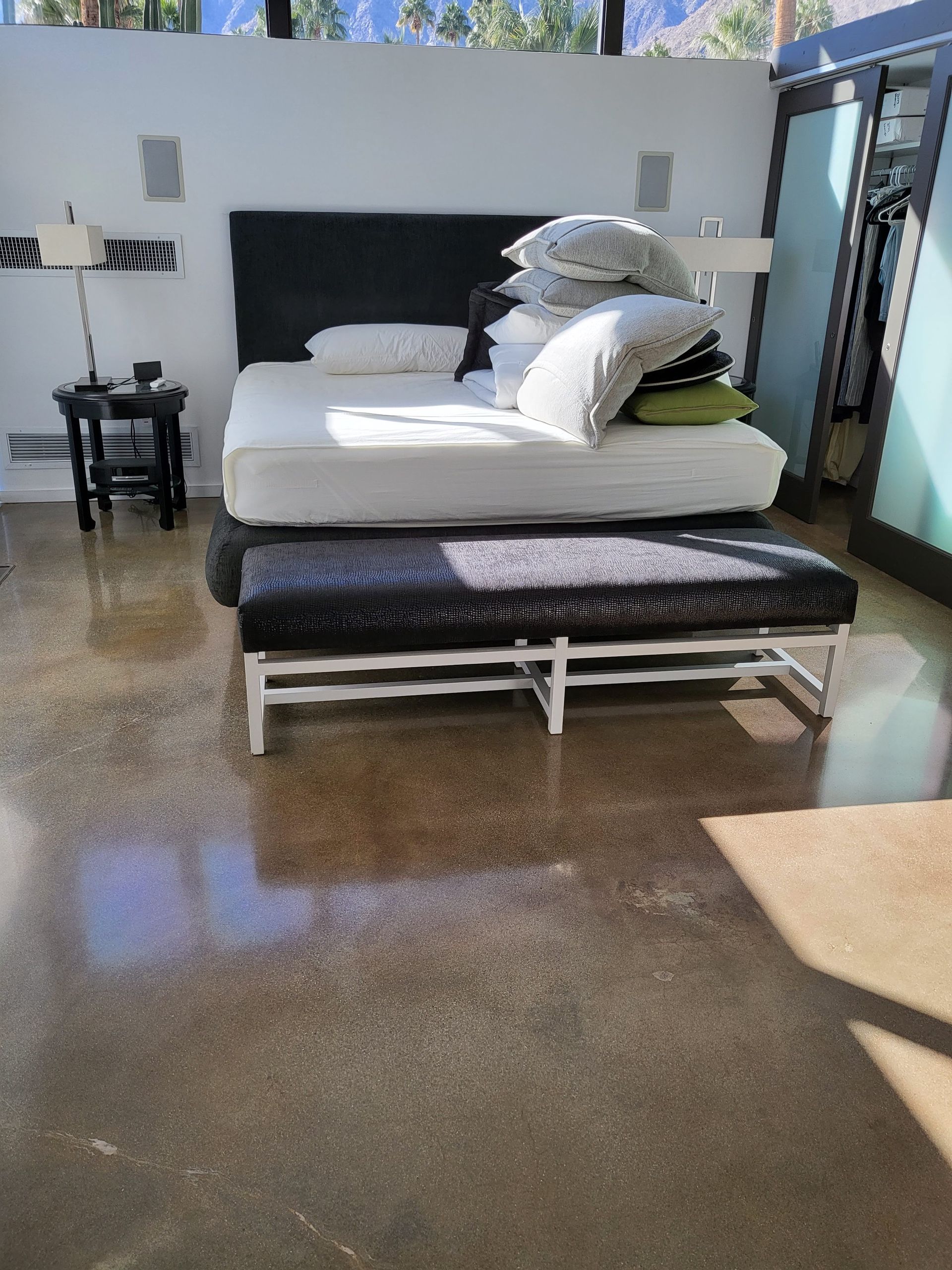 A bedroom with a large bed and two benches