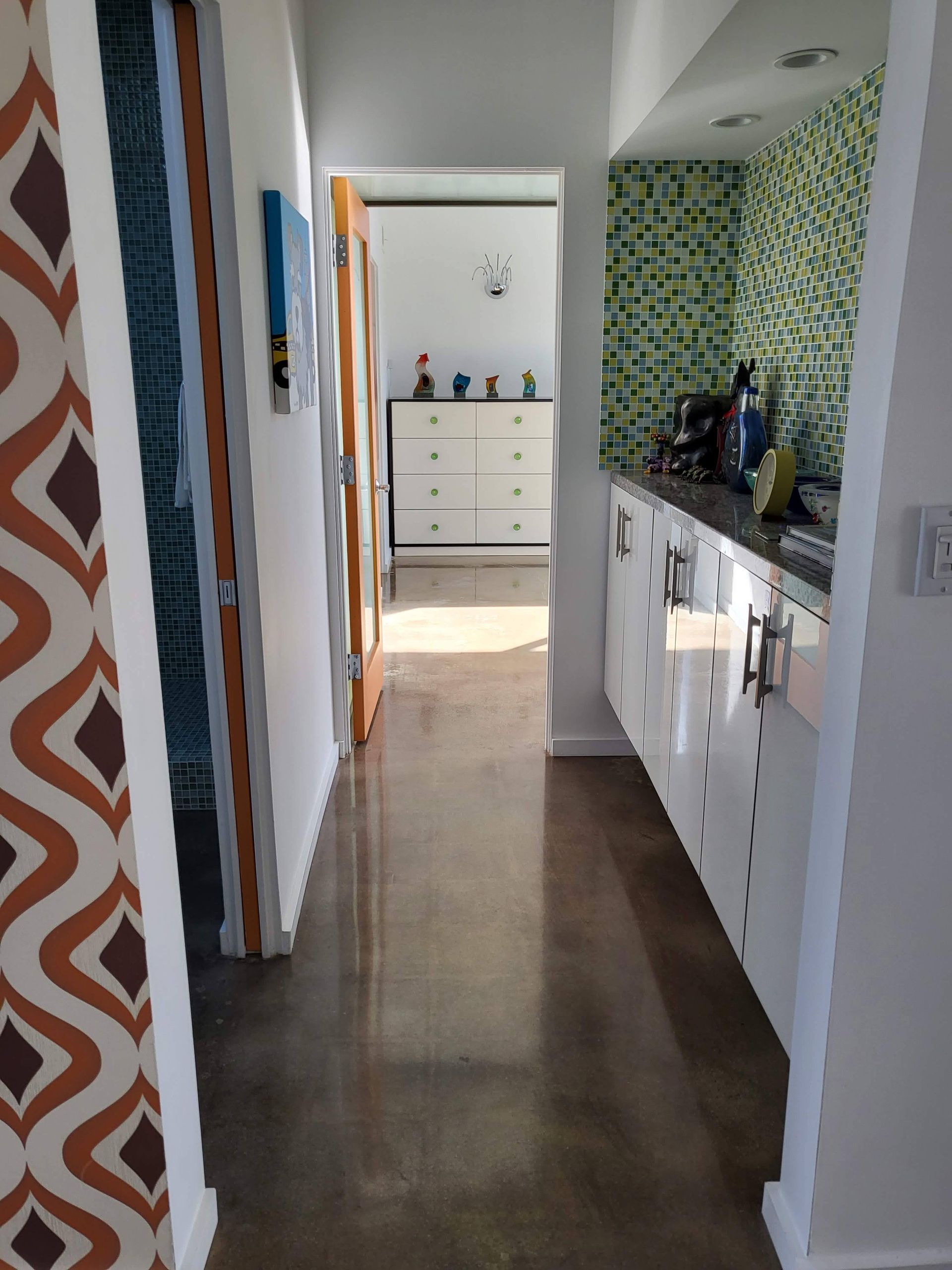 A hallway in a house leading to a kitchen